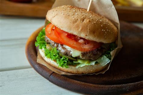 Big Tasty Burger On A Wooden Table And French Fries Stock Image