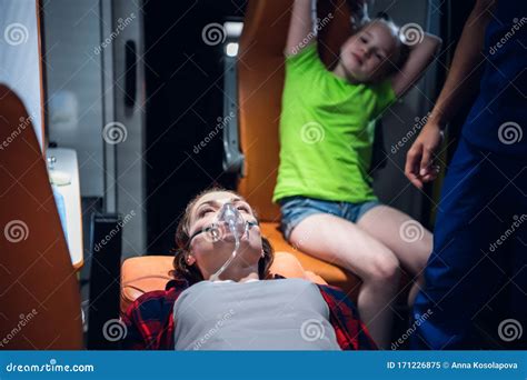 Paramedic Puts Oxygen Mask On Patient In Ambulance Royalty Free Stock Image