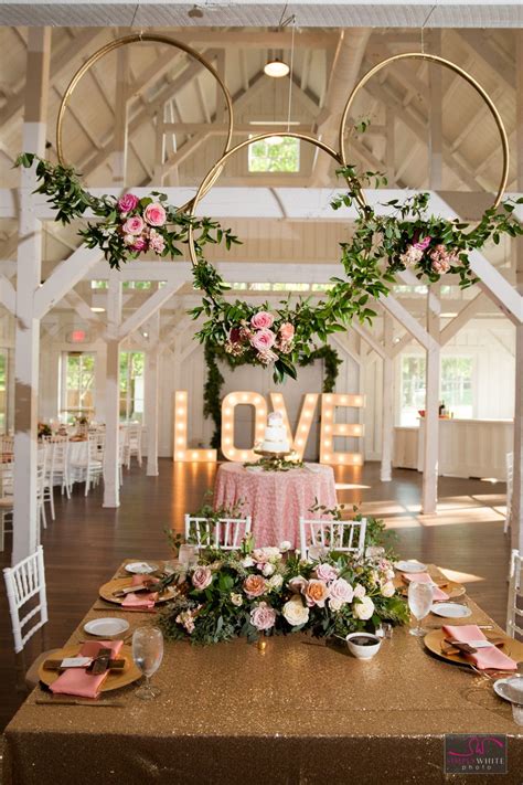 An Indoor Wedding Venue Decorated With Pink Flowers And Greenery