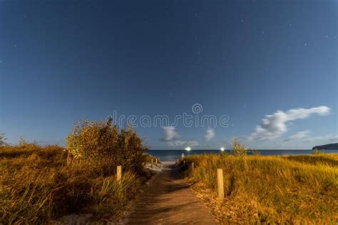 Long Exposure Shot Of A Starry Night Sky Over A Beach Path In The