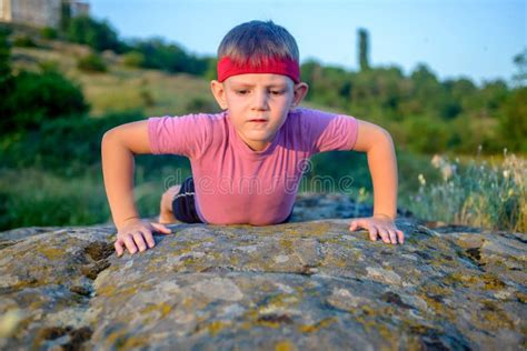 Young Boy Doing Push Ups On A Rock Stock Image Image Of Child Summer