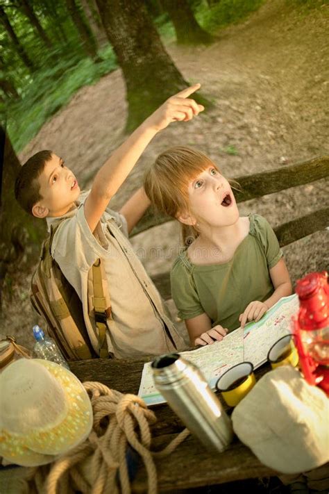 Children On A Camping Trip Learning How To Read And Use A Map Stock