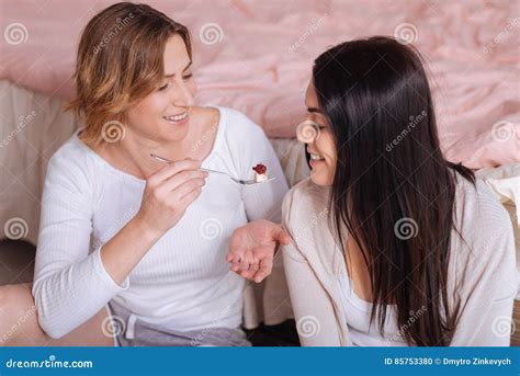 Delighted Attractive Women Feeding Each Other Cake Stock Photo Image