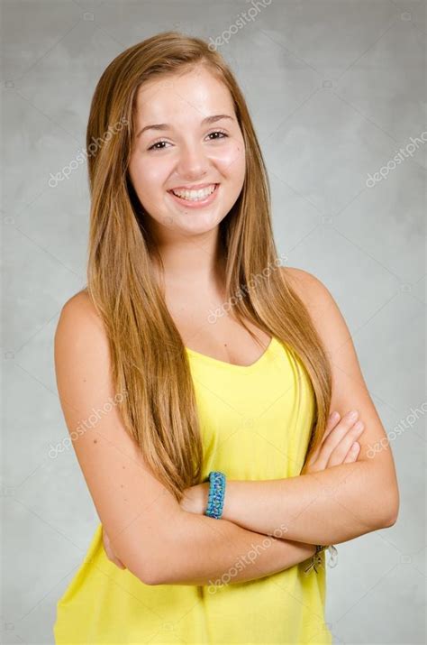 Studio Portrait Of Happy Pretty Teen Girl Smiling Stock Photo By