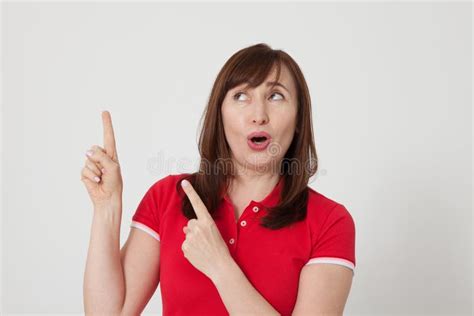 Middle Aged Woman Surprised And Showing Up By Her Fingers On White