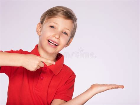 Portrait Of Cheerful Boy Pointing To The Right Isolated Over White