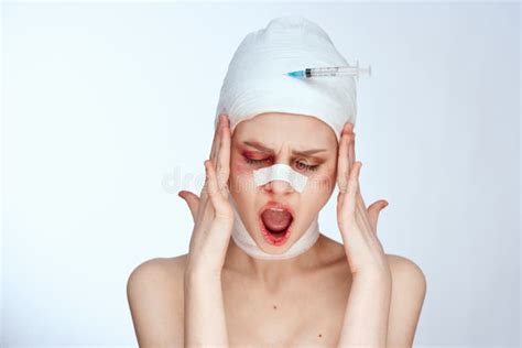 portrait of a woman bandaged face the syringe sticks out in the head isolated background stock