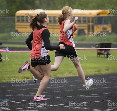 Two Sprinters Crossing The Finish Line Stock Photo Download Image Now
