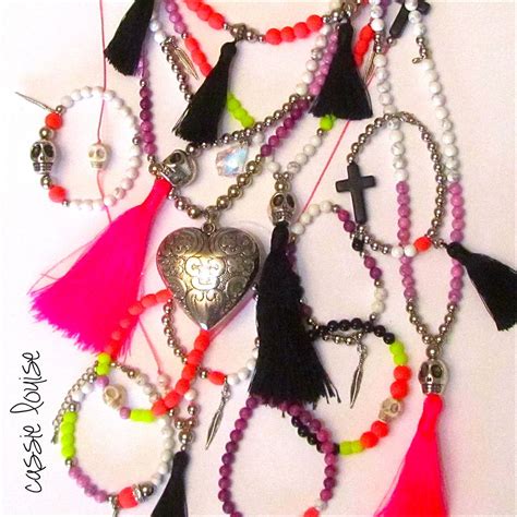a collection of cassie louise bracelet and necklace sample pieces from the neon skulls range