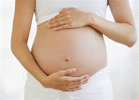 Pregnant Woman With Hands On Belly Stock Photo Dissolve