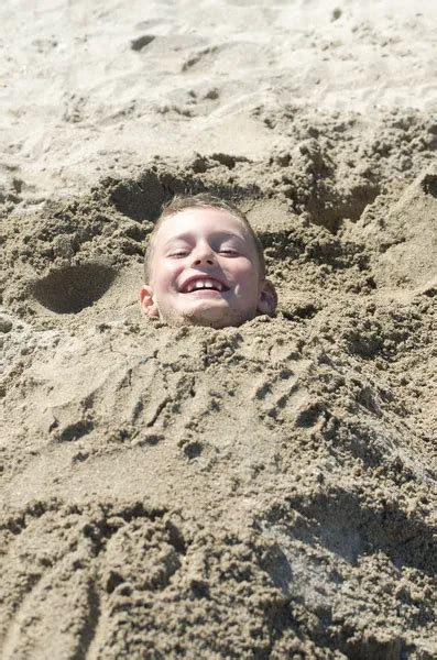 Child Buried In The Sand Stock Photo By ©gelpi 9433393