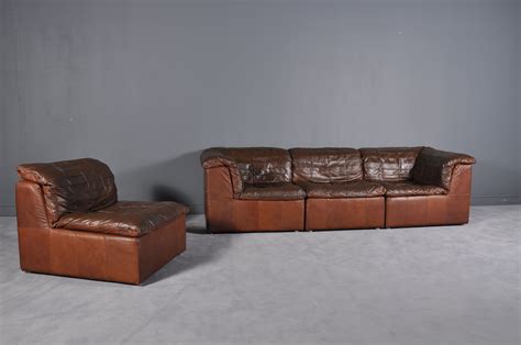 Smart pieces of convertible furniture for small spaces. Vintage cognac leather patchwork modular sofa from Laauser - Design Market