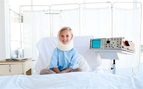 Premium Photo A Patient With A Neck Brace Sitting On A Hospital Bed