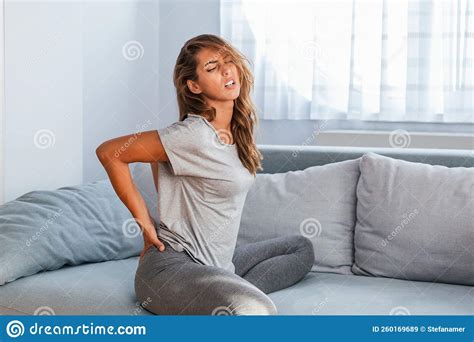 Woman Suffering From Backache At Home Lower Back Pain Stock Image