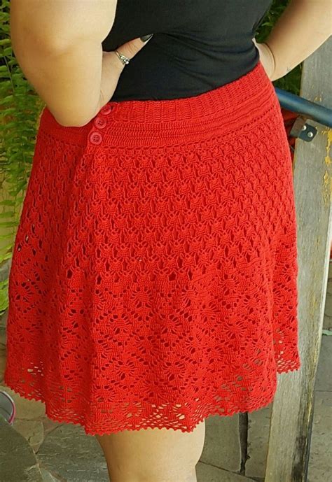 A Woman Wearing A Red Crochet Skirt And Black Shirt Is Standing On Stairs