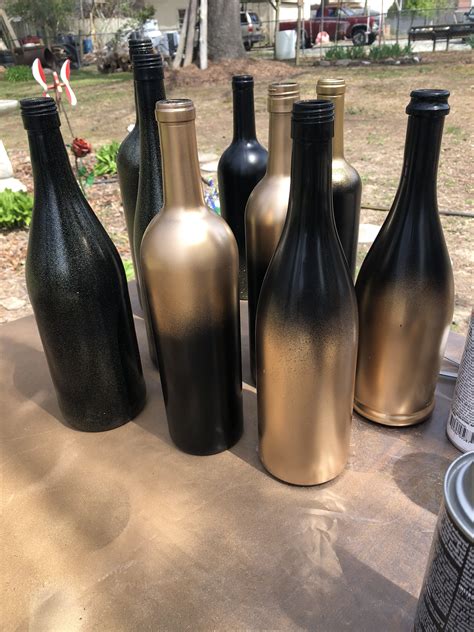 Gold wine bottle wedding centerpiece glitter decor painted. Black & gold wine bottle centerpieces | Wine bottle ...