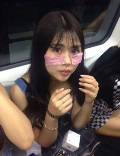 Chinese Ladies Spotted Riding Train With Condoms On Their Face For