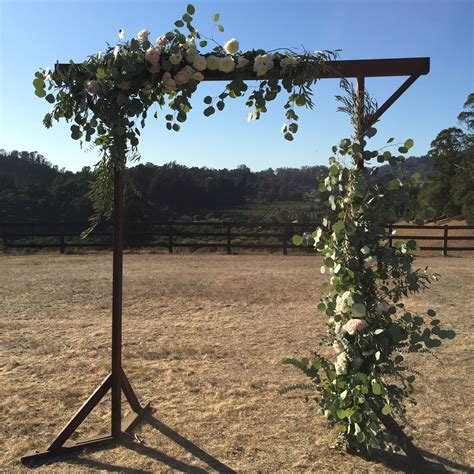 Rustic Wooden Arbor Embellished With Greenery And Creamy Blooms Haute