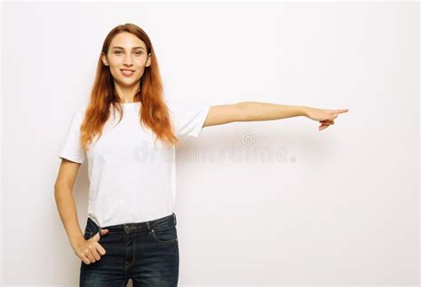 Young Woman Pointing With Finger At Blank Copy Space Aside Happy