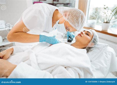 Professional Skilled Female Dermatologist Using A Dermoscope Stock