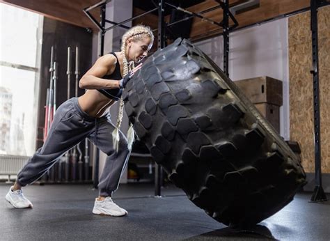 Premium Photo Fit Female Athlete Flipping Huge Tire Woman Lifts A