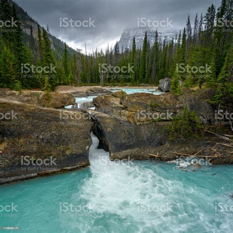 Natural Bridge And Sinkhole Rock Formation Over Kicking Horse River In
