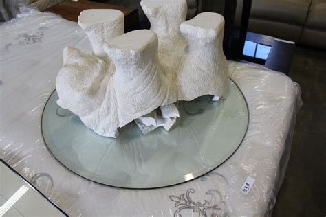 It is in very good condition and looks elegant. POLAR BEAR GLASS TOP COFFEE TABLE