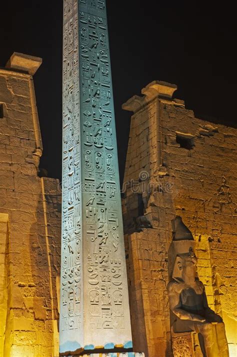 Statue And Obelisk At Entrance To Luxor Temple During Night Stock Image