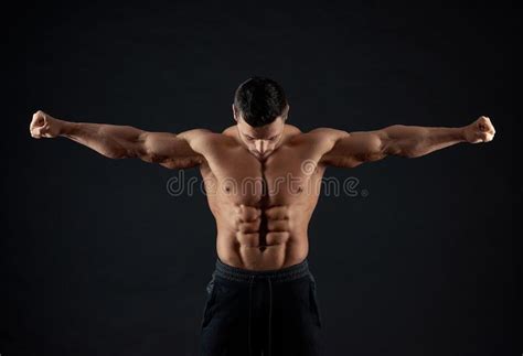 Frontview Of Strong Sportsman Demonstrating Arm Muscles Stock Image