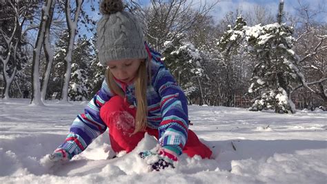 4k Little Girl Playing In Snow In Winter View Of A Happy