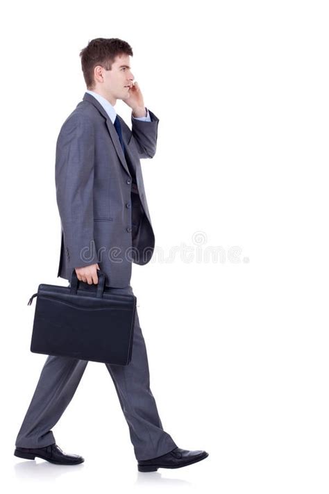 Man Walking And Talking On Phone Side View Of A Hurrying Business Man Talking O Spon Phone