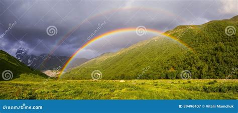 Colorful Rainbow Among High Mountains Royalty Free Stock Photography