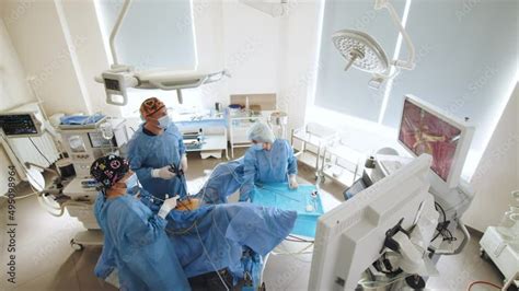 Surgeons Team Preforming Operation In Hospital Operating Theater Male