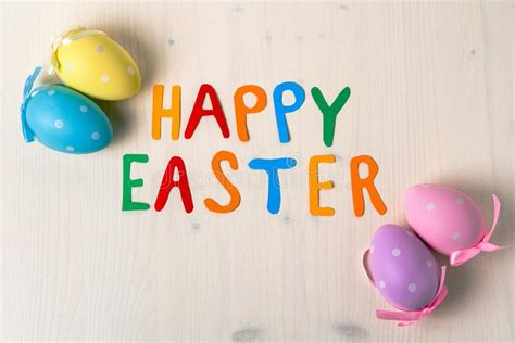 Easter Eggs And The Text Happy Easter On Wooden Background Stock Image