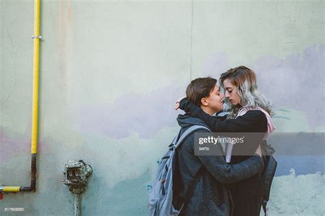 Lesbian Couple Embracing On Back Street Bildbanksbilder Getty Images
