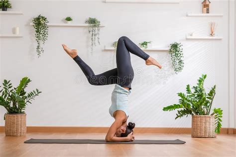Side View Of Asian Woman Wearing Sportwear Doing Yoga Exercise In Front