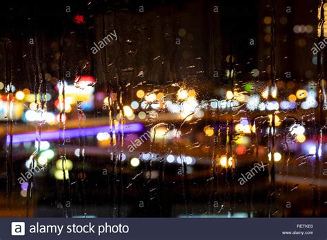 Rain Drops On Window With Road Light Bokeh City Life In Night In Rain