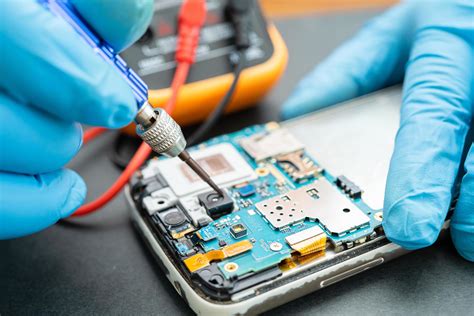 Technician Repairing Inside Of Mobile Phone By Soldering Iron 3173299