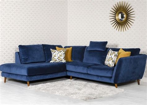 A Living Room With A Blue Couch And Pillows On The Floor Next To A