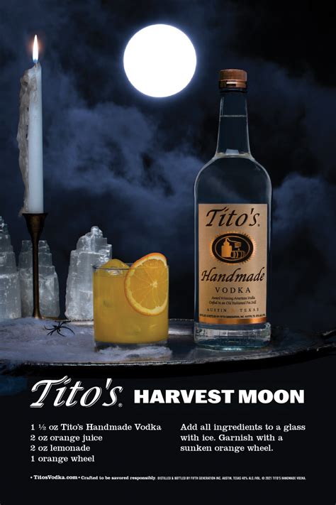 In Front Of A Full Moon And A Cloudy Sky Is A Bottle Of Titos Handmade Vodka To The Right Of A