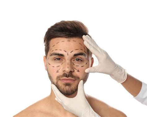 Doctor Examining Man S Face With Marker Lines For Plastic Surgery