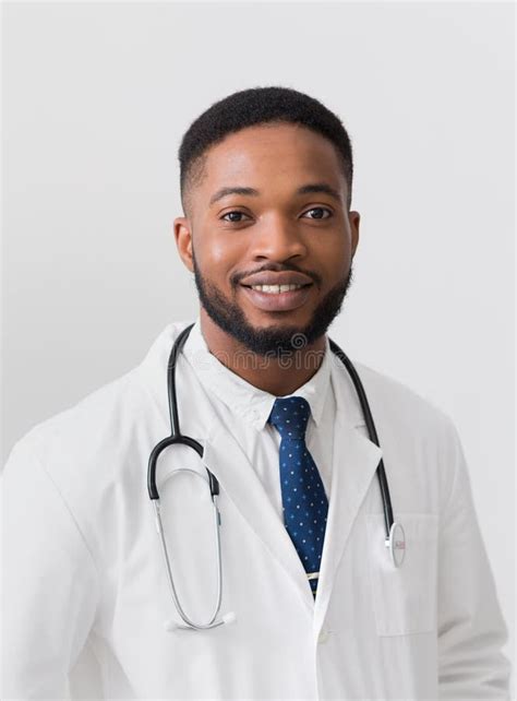 African American Doctor In White Uniform Against White Background Stock