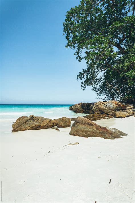 White Sanded Tropical Beach With Big Rocks And A Jungle By Stocksy
