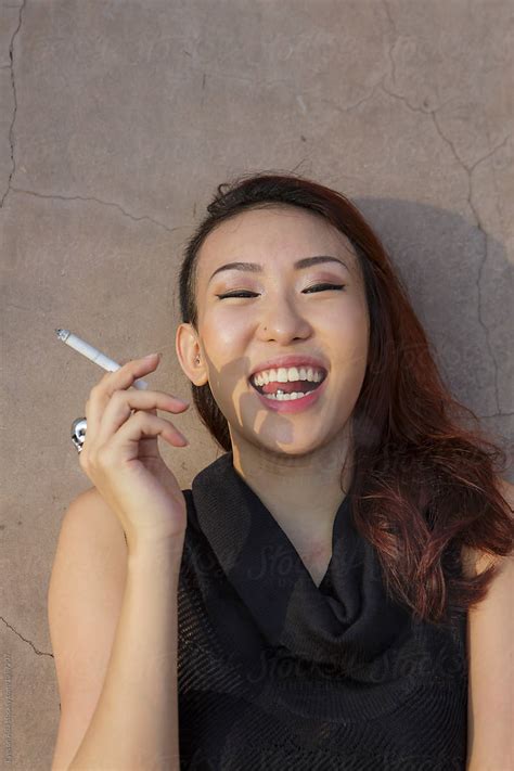 edgy asian girl smoking by stocksy contributor eyes on asia stocksy