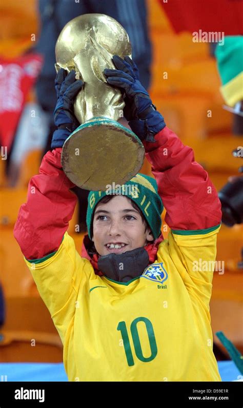 A Child With A World Cup Trophy Replica In The Stands Prior The Fifa