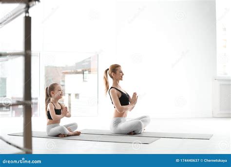 mother and daughter in matching sportswear doing yoga at home stock image image of preschooler