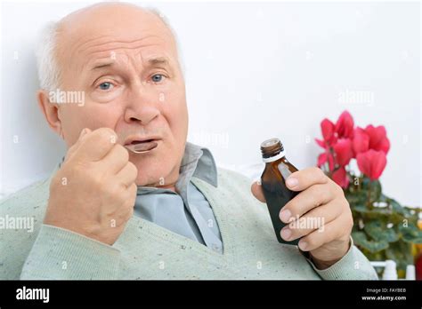 Elderly Gentleman Takes In His Cough Syrup Stock Photo Alamy