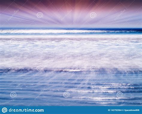 Dramatic Sun Rays Over The Tidal Waves Of Ocean Backdrop Stock Photo