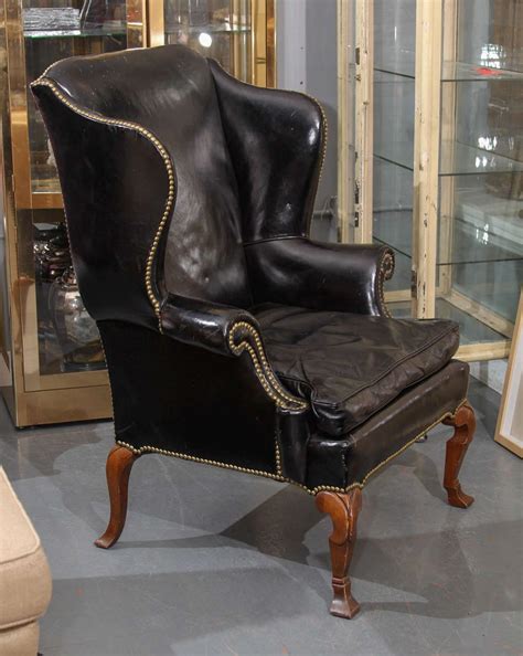 Wingback chairs were invented in the 17th century to be fireside chairs—i.e. Black Leather Wing Chair image 2