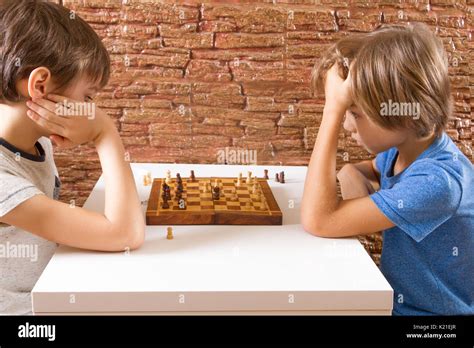 Two Children Playing Chess At The Table Stock Photo Alamy